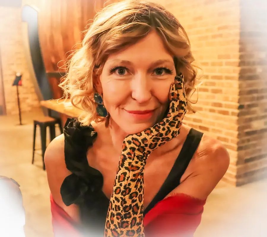 Portrait of Denise Choate in a red dress and leopard-print glove